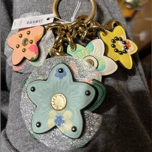 NWT Coach Mystical floral leather bag Charm with gold hardware.